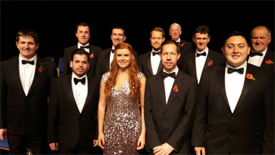 Members of Rhos Male Voice choir with soloists Luis Gomes (2nd from L), Meinir Wyn Roberts (centre) and acting musical director Kevin Whitley (2nd from R)